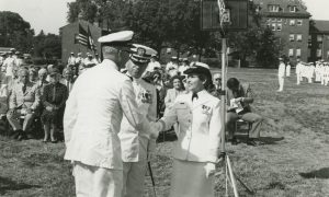 Black and white film of soldiers shaking hands in ceremony