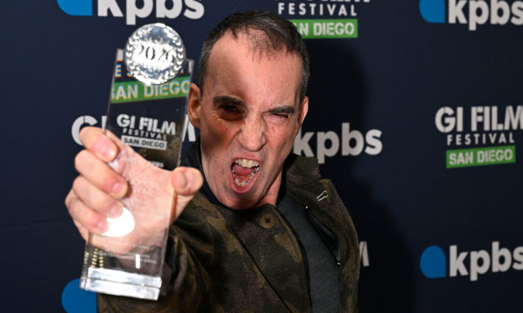 Filmmaker Steve Nemsick holds his GIFFSD 2026 award for "Ugo: An Artist at War"