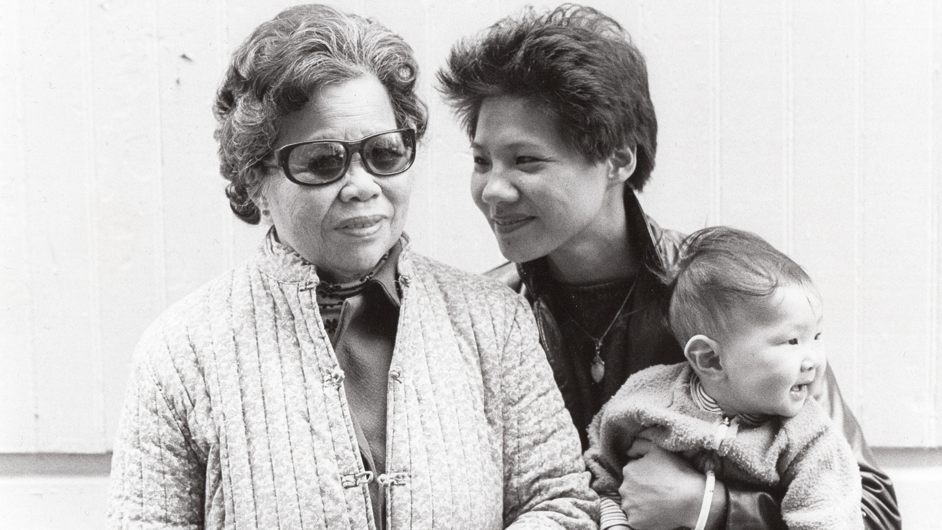 An older Asian woman and younger Asian woman and a baby