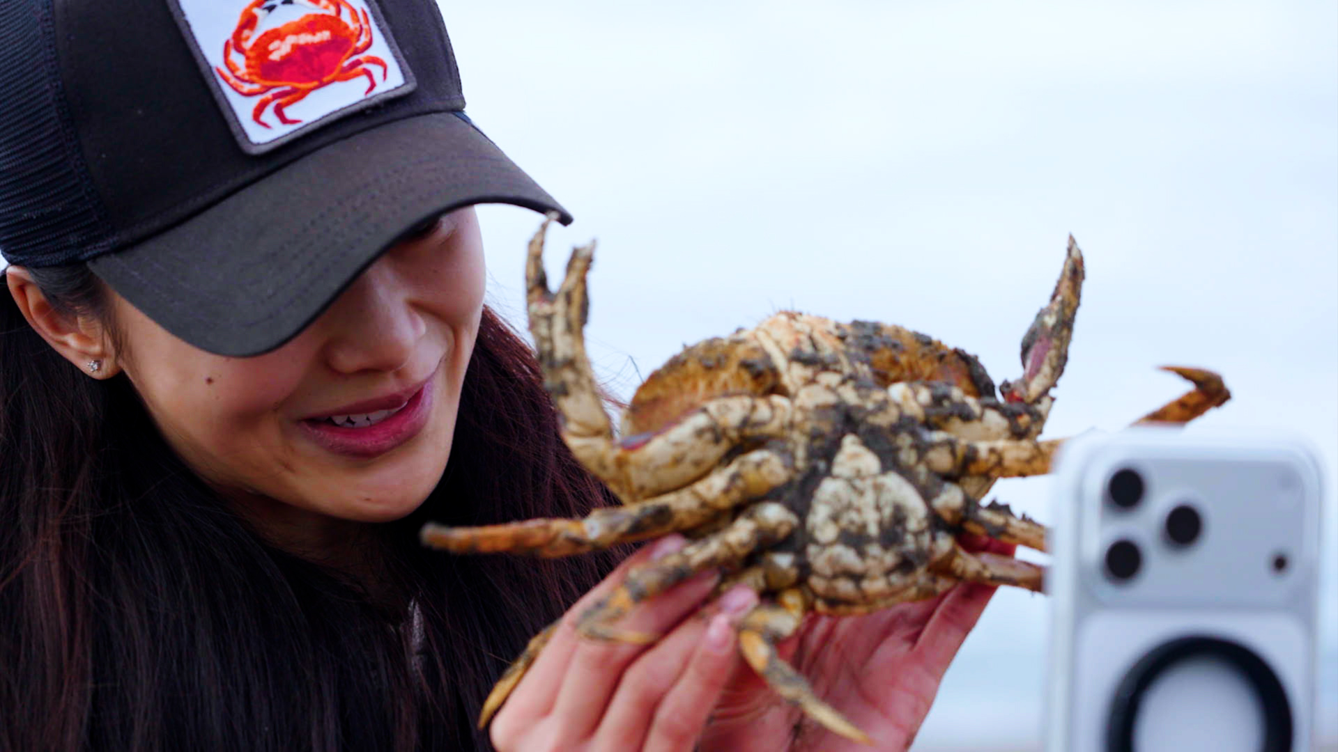 Asian woman holding a crab