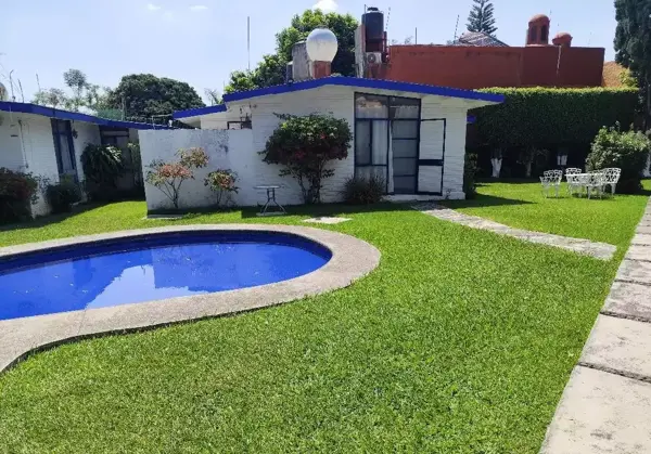 Casa con amplias areas verdes y alberca.