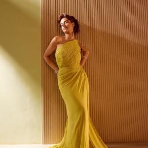 Actress Meenakshi Chaudhary Radiates Elegance in Mustard Yellow One-Shoulder Gown