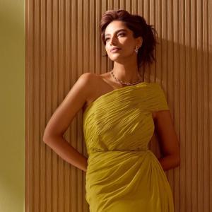 Actress Meenakshi Chaudhary Radiates Elegance in Mustard Yellow One-Shoulder Gown
