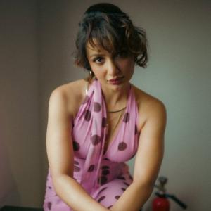 Tejaswi Madiwada in a Chic Pink Polka Dot Dress - Elegant and Thoughtful Portrait
