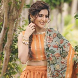 Elegant Portrait of Actress Athulya Ravi in Orange Traditional Outfit with Floral Dupatta