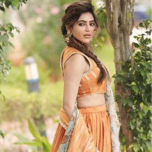 Elegant Portrait of Actress Athulya Ravi in Orange Traditional Outfit with Floral Dupatta