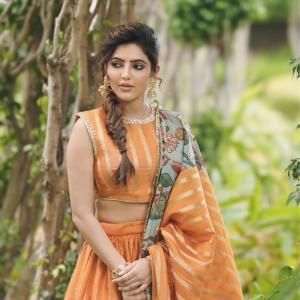 Elegant Portrait of Actress Athulya Ravi in Orange Traditional Outfit with Floral Dupatta