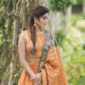 Elegant Portrait of Actress Athulya Ravi in Orange Traditional Outfit with Floral Dupatta