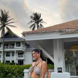 Ruhani Sharma Embraces Tropical Vibes in Halter Top and Green Skirt