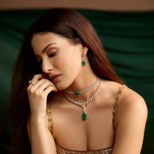 Elegant Golden Sequined Dress with Green Backdrop - Fashion Photoshoot