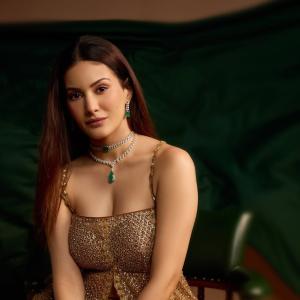 Elegant Golden Sequined Dress with Green Backdrop - Fashion Photoshoot