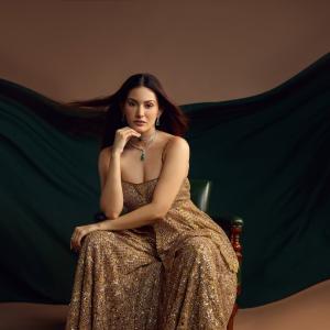 Elegant Golden Sequined Dress with Green Backdrop - Fashion Photoshoot