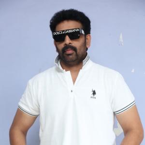 J.D. Chakravarthi Flaunts Stylish Look in White Polo and Designer Shades