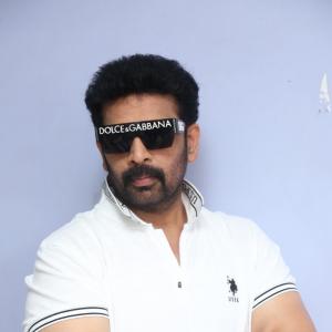 J.D. Chakravarthi Flaunts Stylish Look in White Polo and Designer Shades
