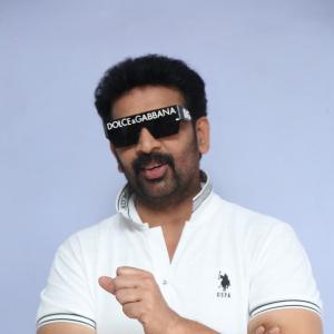 J.D. Chakravarthi Flaunts Stylish Look in White Polo and Designer Shades