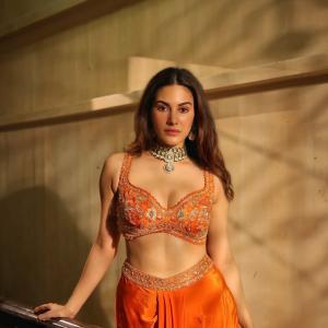 Amyra Dastur Stuns in Vibrant Orange Embellished Saree-Inspired Outfit