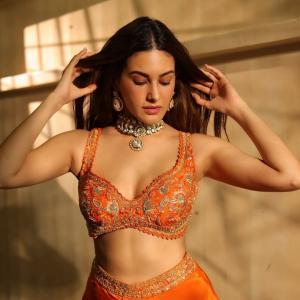Amyra Dastur Stuns in Vibrant Orange Embellished Saree-Inspired Outfit