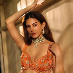 Amyra Dastur Stuns in Vibrant Orange Embellished Saree-Inspired Outfit