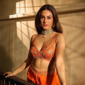 Amyra Dastur Stuns in Vibrant Orange Embellished Saree-Inspired Outfit