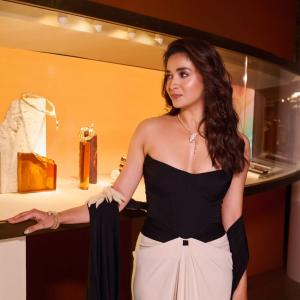 Elegant Black and Cream Outfit with Chic Accessories and Modern Makeup