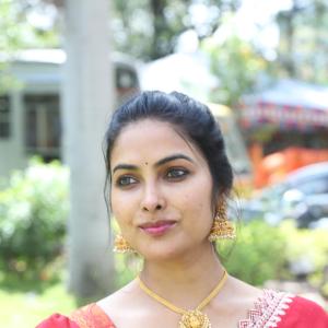 Actress Divi in Elegant Red Saree with Gold Jewelry