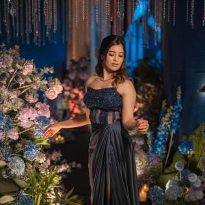 Actress Amrita Iyer Looks Stunning in Elegant Navy Blue Gown Amid Floral Decor