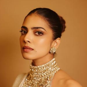 Actress Malavika Mohanan Radiates Golden Elegance and Timeless Beauty