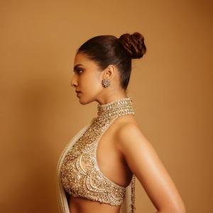 Actress Malavika Mohanan Radiates Golden Elegance and Timeless Beauty