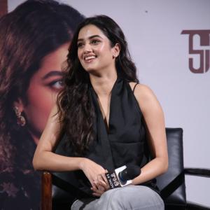 Bhagya Sree Borse Looks Chic in Black Sleeveless Top and Grey Pants at Media Event