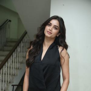 Bhagya Sree Borse Looks Chic in Black Sleeveless Top and Grey Pants at Media Event