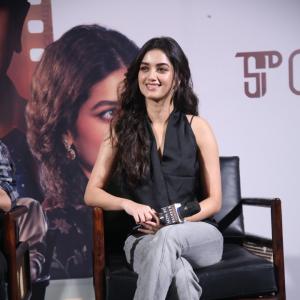 Bhagya Sree Borse Looks Chic in Black Sleeveless Top and Grey Pants at Media Event