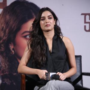 Bhagya Sree Borse Looks Chic in Black Sleeveless Top and Grey Pants at Media Event