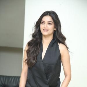Bhagya Sree Borse Looks Chic in Black Sleeveless Top and Grey Pants at Media Event