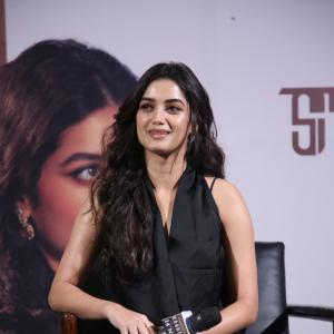 Bhagya Sree Borse Looks Chic in Black Sleeveless Top and Grey Pants at Media Event