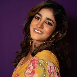 Actress Dimple Hayathi in a yellow floral saree photoshoot against purple background