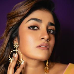 Actress Dimple Hayathi in a yellow floral saree photoshoot against purple background