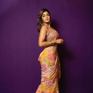 Actress Dimple Hayathi in a yellow floral saree photoshoot against purple background