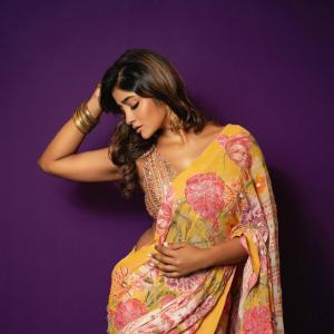 Actress Dimple Hayathi in a yellow floral saree photoshoot against purple background