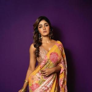 Actress Dimple Hayathi in a yellow floral saree photoshoot against purple background