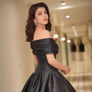 Actress Kajal Agarwal stuns in elegant black off shoulder gown at indoor event