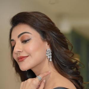 Actress Kajal Agarwal stuns in elegant black off shoulder gown at indoor event