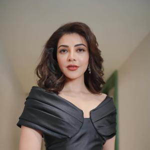 Actress Kajal Agarwal stuns in elegant black off shoulder gown at indoor event