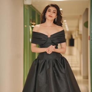 Actress Kajal Agarwal stuns in elegant black off shoulder gown at indoor event