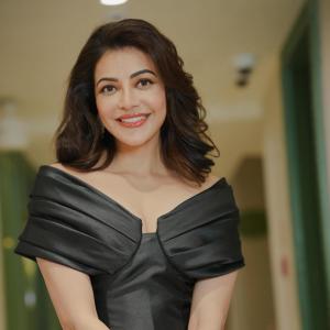 Actress Kajal Agarwal stuns in elegant black off shoulder gown at indoor event
