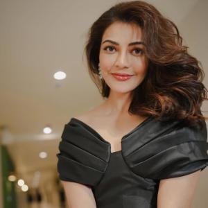 Actress Kajal Agarwal stuns in elegant black off shoulder gown at indoor event