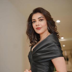Actress Kajal Agarwal stuns in elegant black off shoulder gown at indoor event