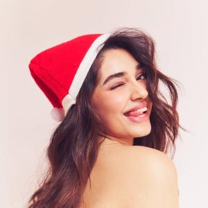 Actress Kriti Shetty Festive Christmas Look in Santa Hat with Playful Holiday Vibes