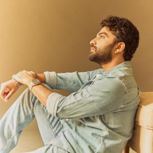 Actor Vishwak Sen's Casual Yet Stylish Look in a Denim Shirt and Relaxed Pose