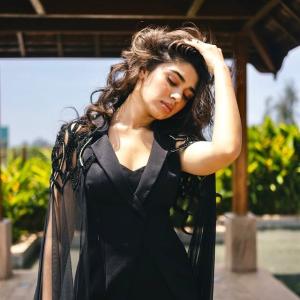 Kriti Shetty: Elegant Black Outfit with Sheer Cape Fashion Look