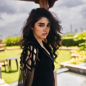 Kriti Shetty: Elegant Black Outfit with Sheer Cape Fashion Look